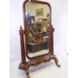 A good C19th figured mahogany cheval mirror, with panelled back, octagonal supports and serpentine