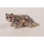 A sterling silver fox with ruby set eyes, 1½" long