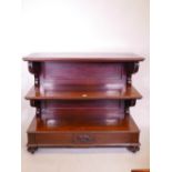 A Vicotorian mahogany three tier buffet with scrolled supports, single frieze drawer, and