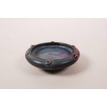 A small Chinese Jun glazed pottery trinket dish with a rolled rim, 3" diameter
