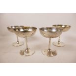 Four sterling silver stemmed dessert bowls, hallmarked Elkington and Co., Birmingham, 1922, with the
