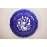 A Chinese mottled blue ground pottery charger of lobed form with raised lotus flower bouquet