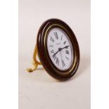 A Cartier 'Baignoire Pendulette' quartz alarm desk clock with a gilt case and faux bois surround,