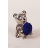 A silver pincushion in the form of a bear, 1"