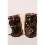 A pair of lignum vitae African bookends with carved figural decoration, 8" high