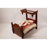 A C19th doll's house mahogany half tester bed, 12" long