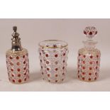 A Baccarat three piece glass dressing table set of perfume decanter, atomiser and tumbler, red and
