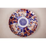 A C19th Japanese Imari porcelain charger decorated with floral panels in the traditional manner, 12"