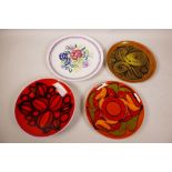 Four Poole pottery plates, two 8" Dolphin pattern, an 8" Aegean and a 9" traditional floral pattern