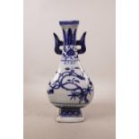 A Chinese blue and white porcelain two handled vase with foliage decoration, 4 character mark to