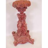 A C19th Burmese carved and pierced hardwood pedestal with dished top, decorated with dragons and