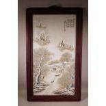 A large Chinese polychrome porcelain panel decorated with a rural winter landscape, mounted in a