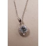 An 18ct white gold, blue topaz and diamond set pendant necklace, approximately 90 points