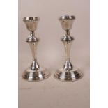 A pair of hallmarked silver candlesticks, Birmingham 1973, maker's mark for W.I. Broadway & Co.,