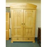 A C19th Continental pine armoire with carved Art Nouveau decoration, two doors over two drawers,