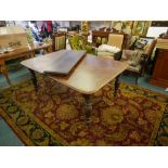 A Victorian mahogany drawleaf dining table, with three leaves, raised on turned supports,46" x 50" x