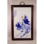 A Chinese blue and white porcelain panel decorated with Shou Lao riding an ox accompanied by an
