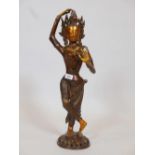 A bronze figure of an Eastern deity, inset with coloured beads, 24" high