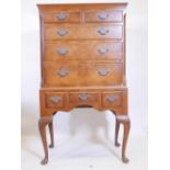 A Queen Anne style walnut chest on stand, with five drawers over three, raised on cabriole supports,