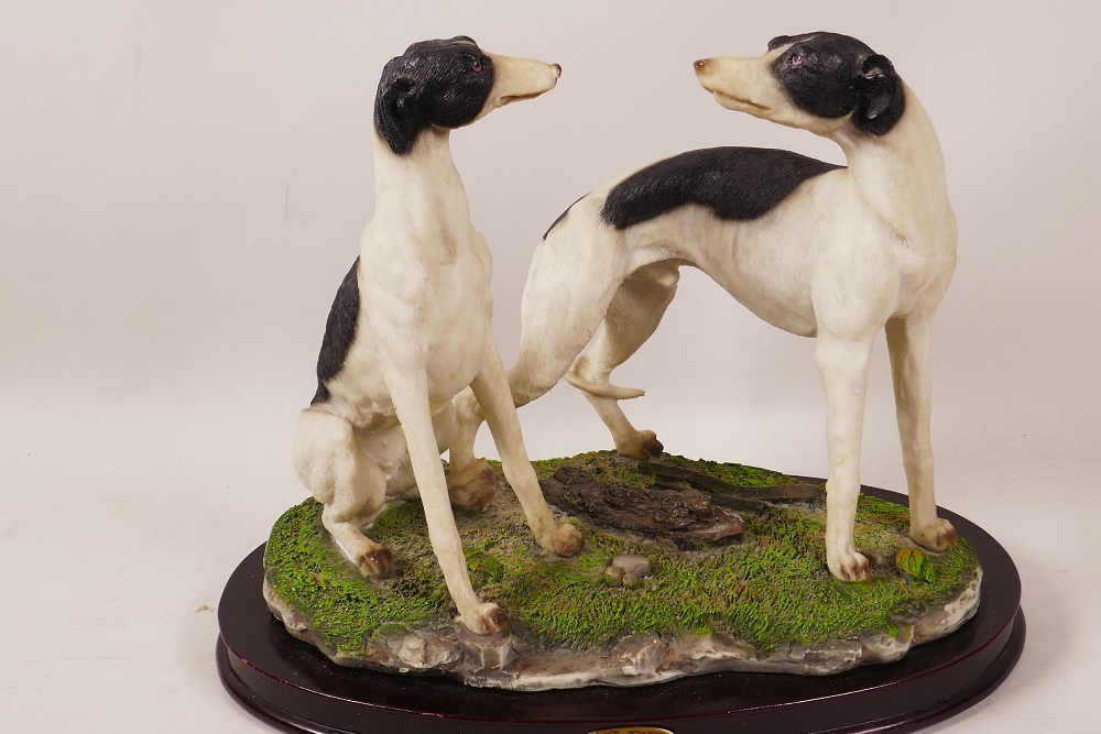 A composition figure of two greyhounds on an oval wooden plinth, 8½" high - Image 2 of 2
