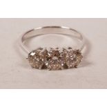 A 14ct white gold, three stone diamond ring, approximately 90 points, approximate size 'N'