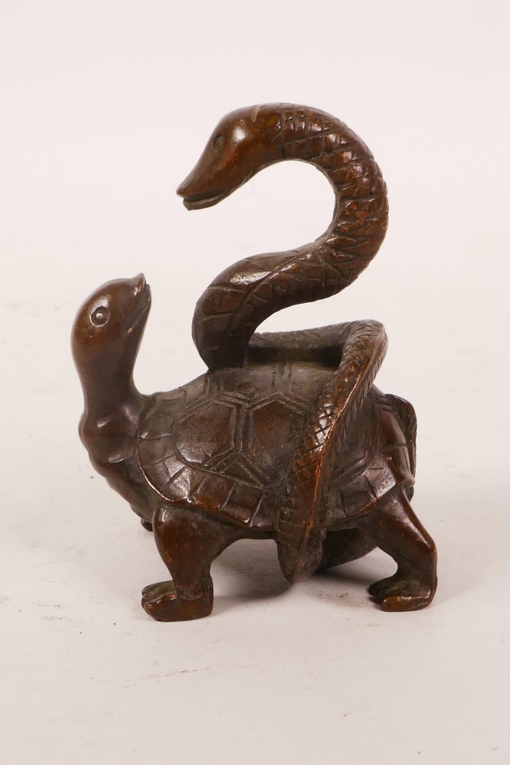 An Oriental bronze of a tortoise with a snake, 2½" high