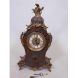 A late C19th French red boulework mantel clock, with gilt metal mounts, raised on dragon supports,