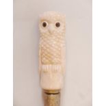 A hardwood walking cane with brass mounts and bone handle, carved in the form of an owl with inset