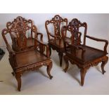 A set of four Chinese hardwood open armchairs, with carved and pierced backs and friezes, raised
