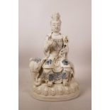 A Chinese blanc de chine figure of Quan Yin on an elephant, with blue details, impressed mark verso,