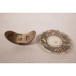 A Chinese white metal coin dish with raised decoration of the emblems of the Eight Immortals,