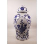 A large Chinese blue and white pottery jar and cover with decorative panels, 18½" high