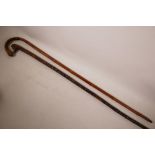 Two Chinese walking sticks, one hardwood with carved sage head handle and carved shaft, 40" long,