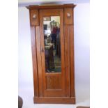 A Harris Lebus oak hall cupboard/wardrobe with pewter and exotic wood inlaid decoration, 37" x 18" x