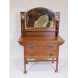 An Arts and Crafts oak dressing table in the Liberty style, 39" x 20", 55" high