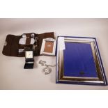 A silver plated photo frame, 11" x 9", another smaller frame, a gentleman's leather cased vanity