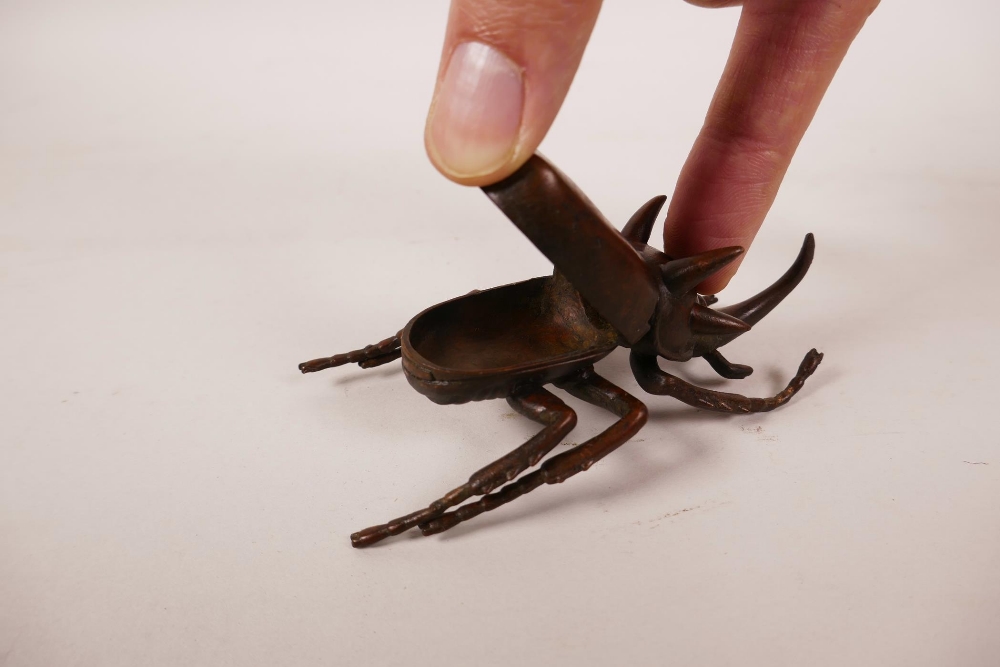 A Japanese Jizai style bronze five horned rhinoceros beetle, the wings hinged to reveal a trinket - Image 2 of 3