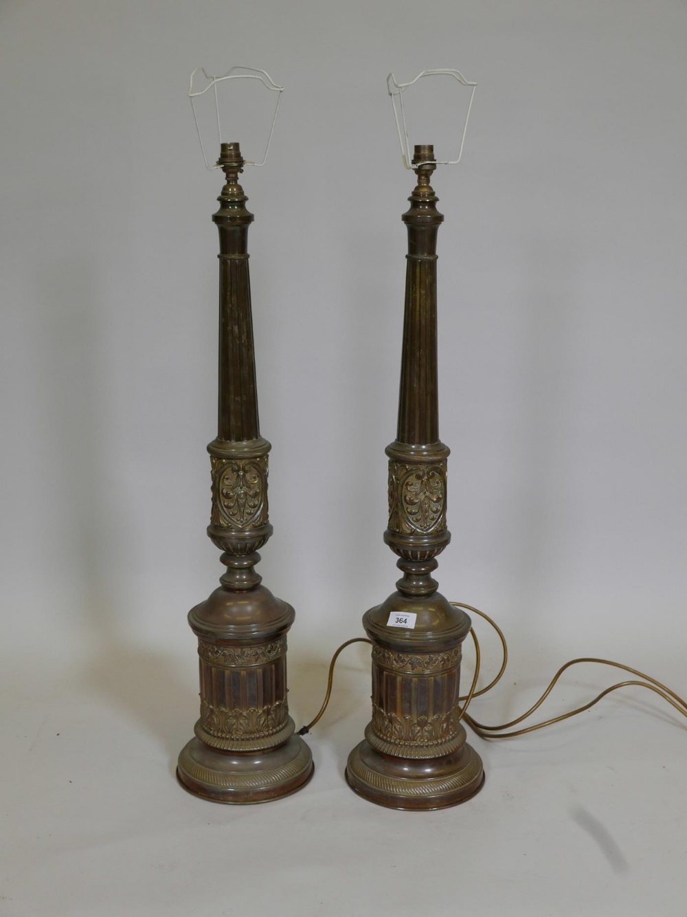 A pair of brass table lamps with repoussé classical decoration, 34" high