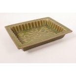A Chinese green glazed pottery trinket dish with a ribbed interior and raised lotus flower