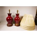 A pair of flambé glazed Oriental vase shaped porcelain table lamps with brass fittings and turned