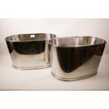 A pair of large chrome plated champagne buckets with engraved quotes from 'Lily Bollinger' and '