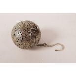 A Chinese white metal incense ball with a gimbal mounted reservoir within, 2" diameter