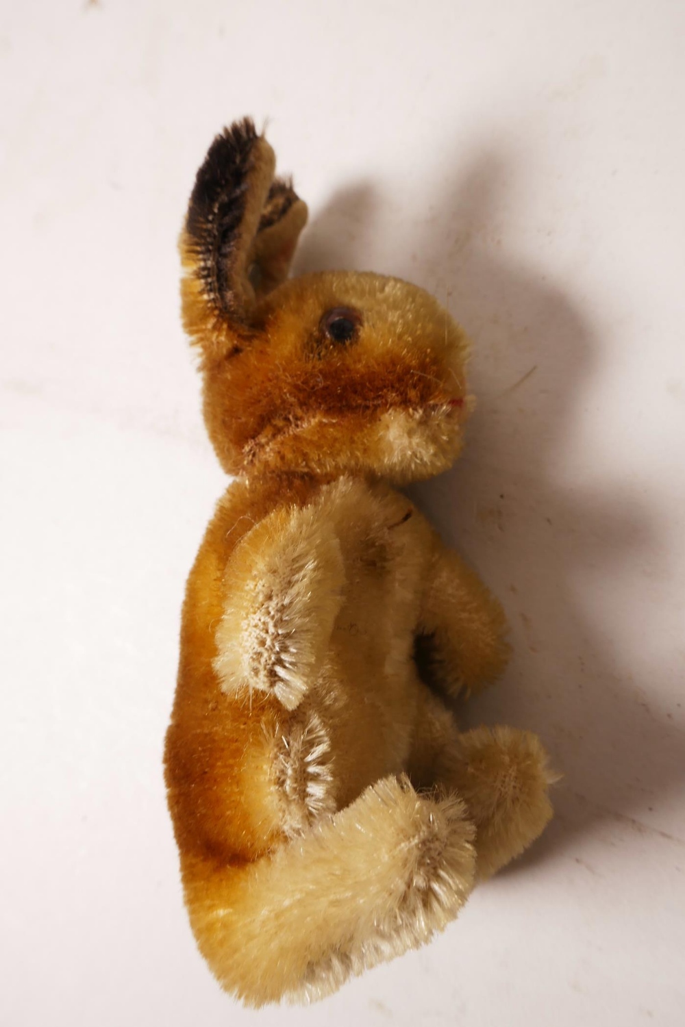 A 1952/53 Steiff begging rabbit, golden mohair, fixed limbs, brown and black glass eyes, red - Image 7 of 8