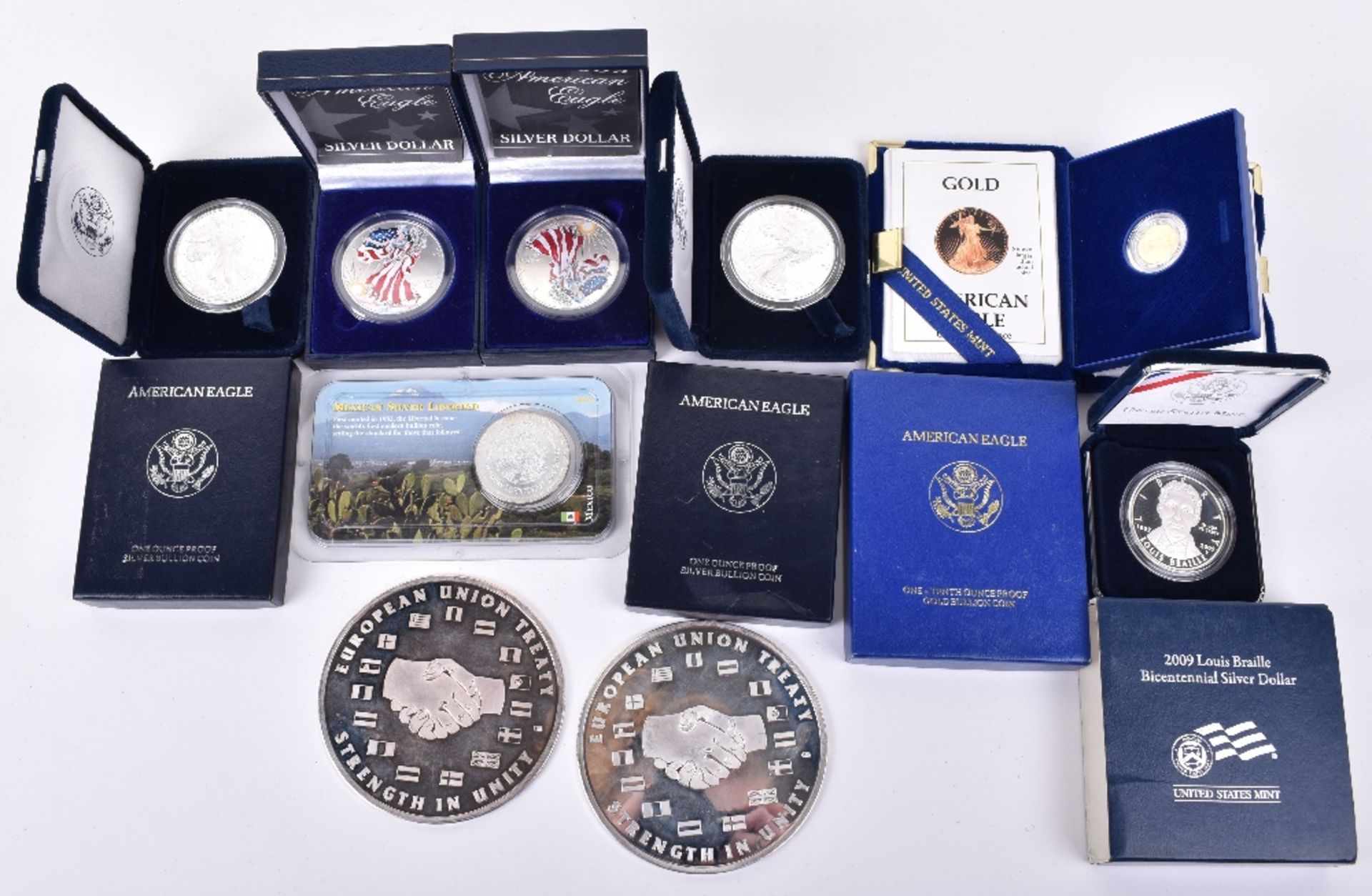 US commemorative coinage, including 1/10th ounce Eagle gold coin, five US silver ounce dollars, a Me