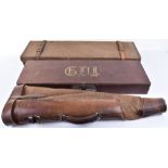 A Joseph Braddell & Sons oak, canvas and leather single gun case with trade label
