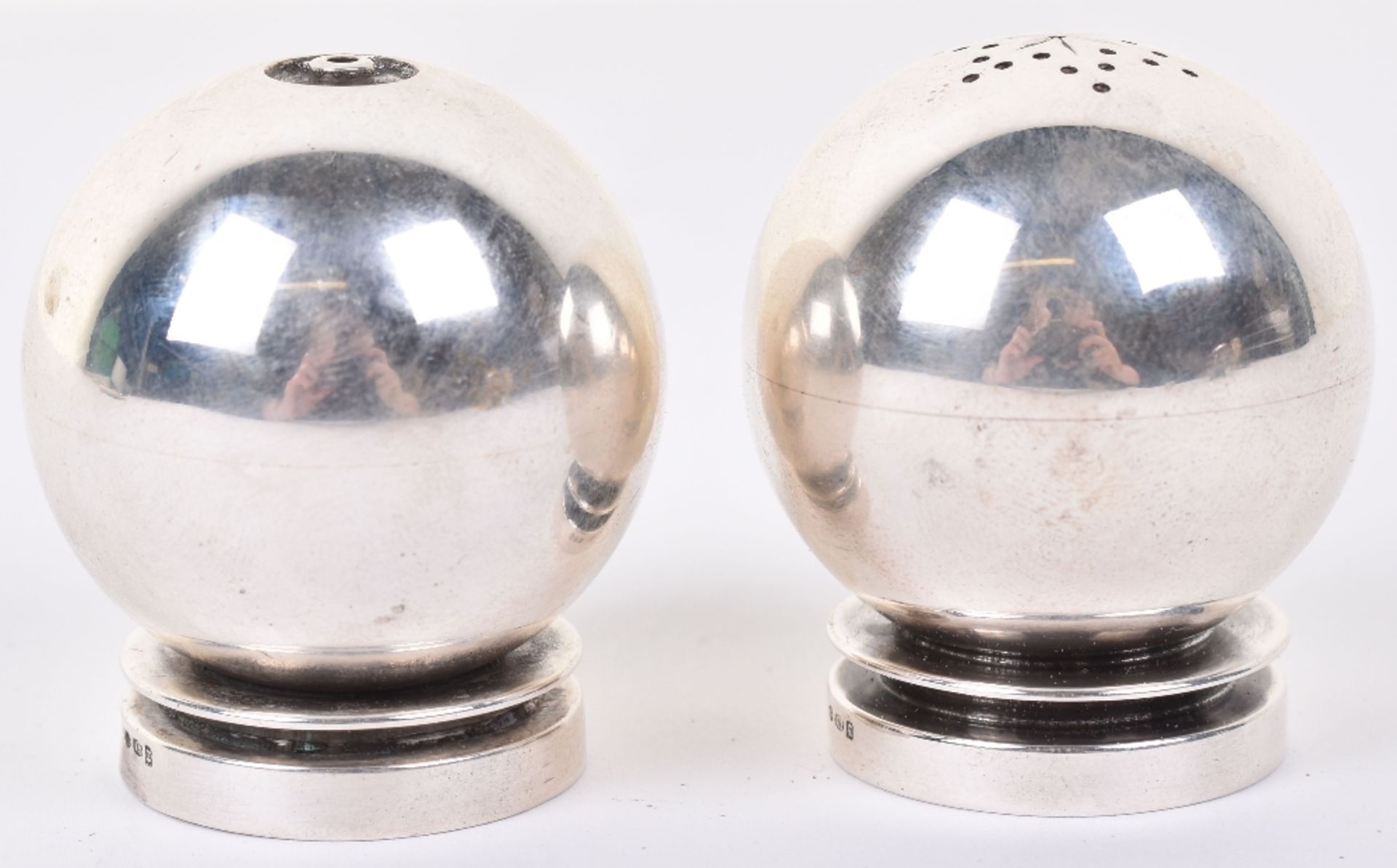 A pair of Georg Jensen silver salt and pepper, 1915-1932, of globular form, design 632, 4cmH