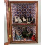 Glazed hanging wall cabinet with dolls and miniatures, dolls circa 1910,