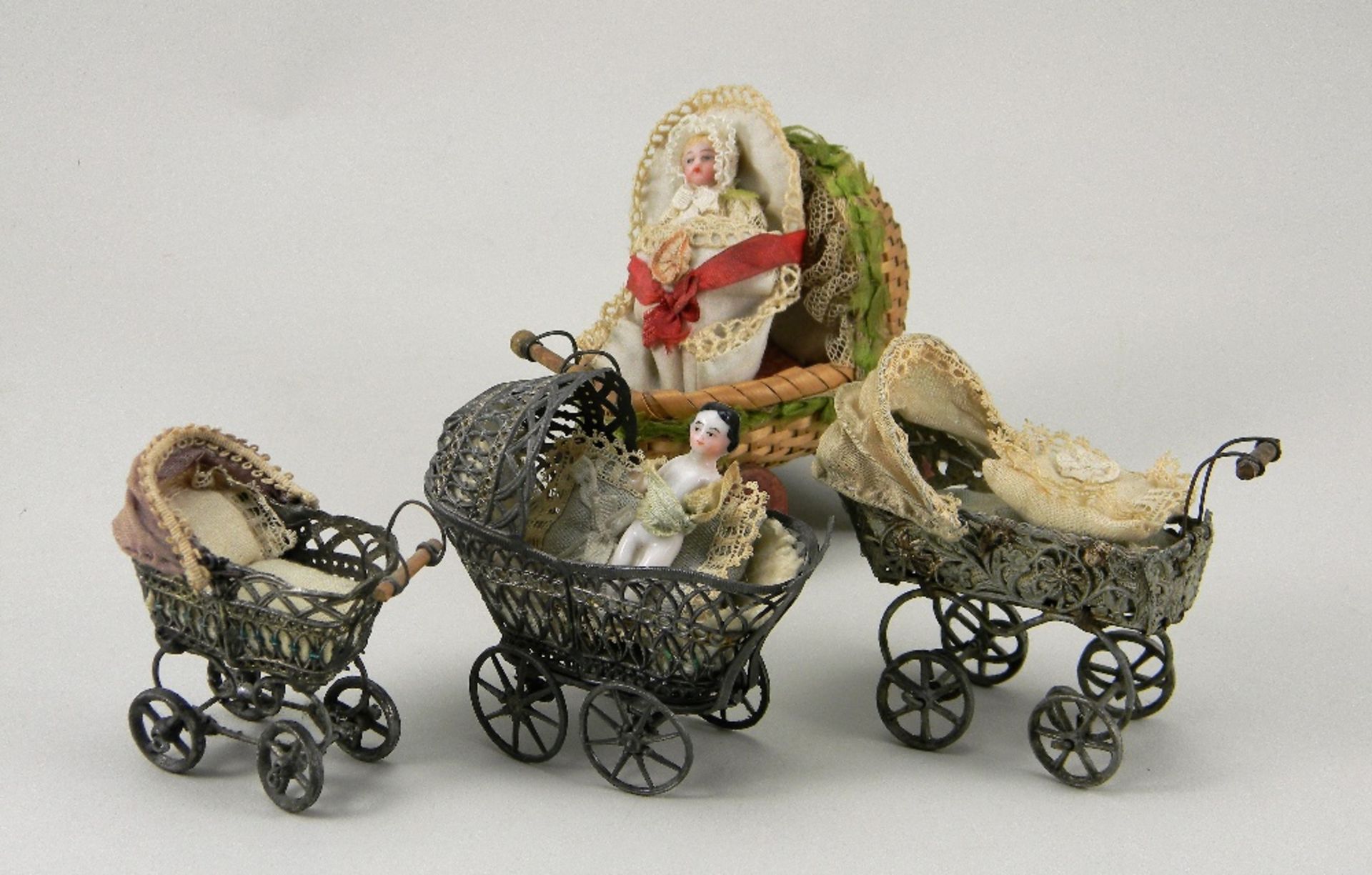 Three soft metal miniature toy prams, German circa 1900,