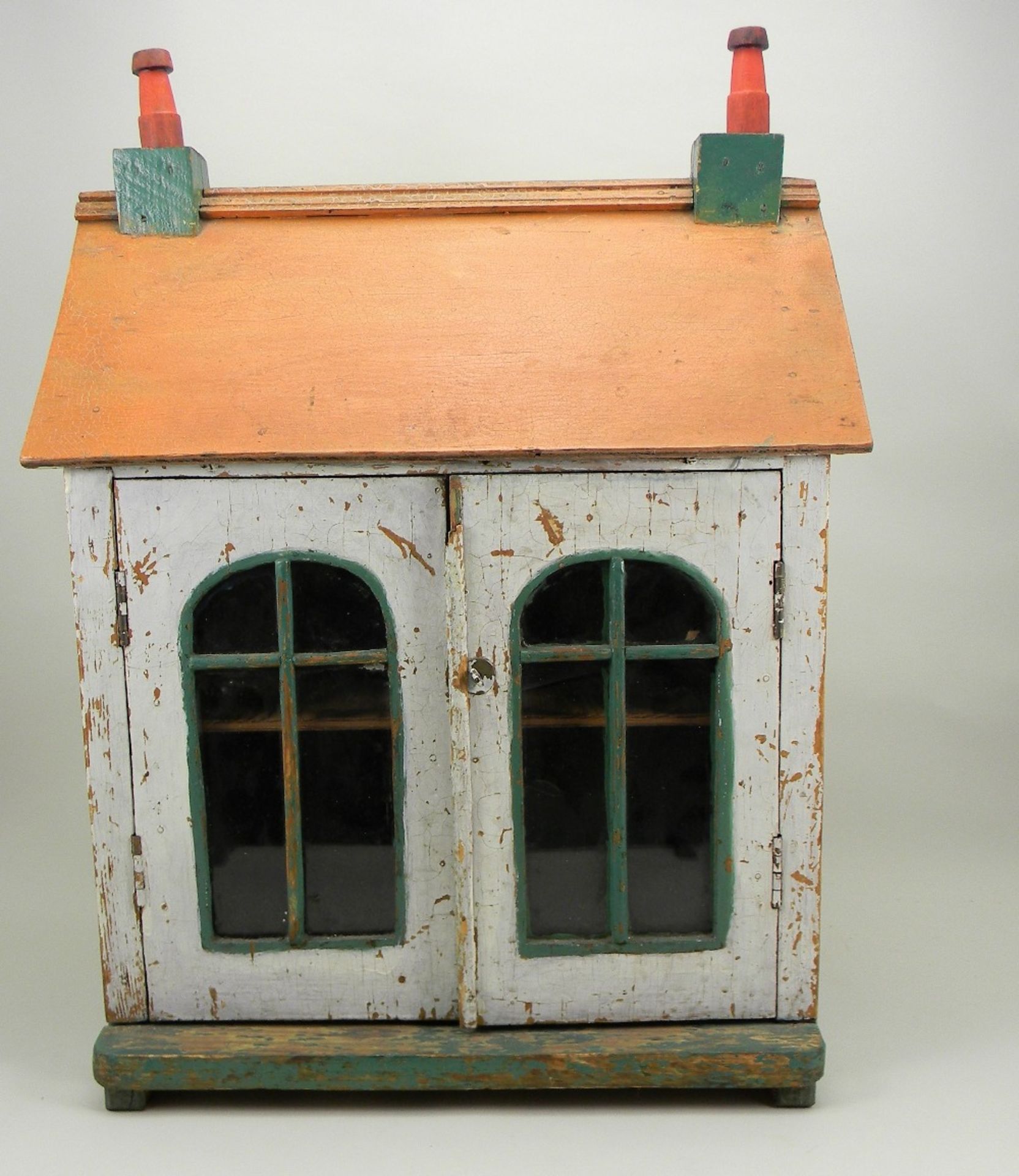 A simple painted wooden dolls house, English early 20th century,