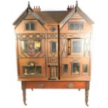 A large and impressive wooden dolls house and contents on stand, probably German circa 1880,